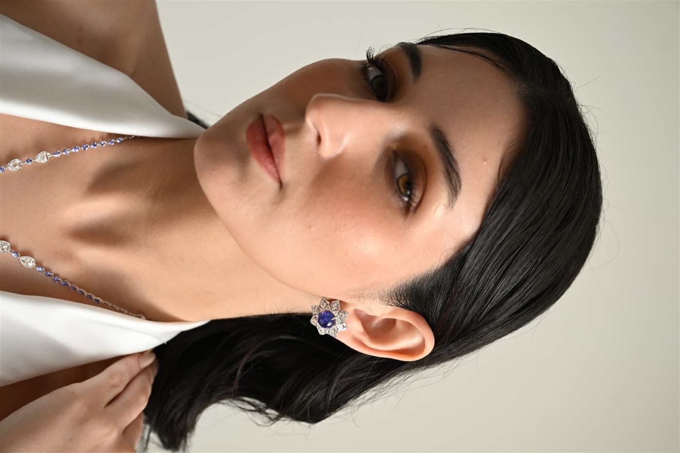 Tanzanite and rose-cut diamond earrings worn by a model